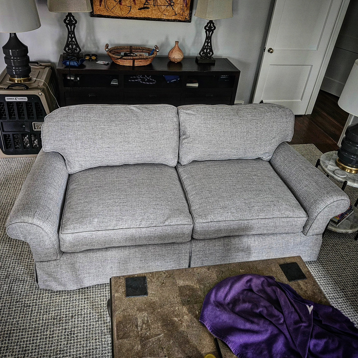 Modern grey sofa, freshly reupholstered, styled in a customer's living room