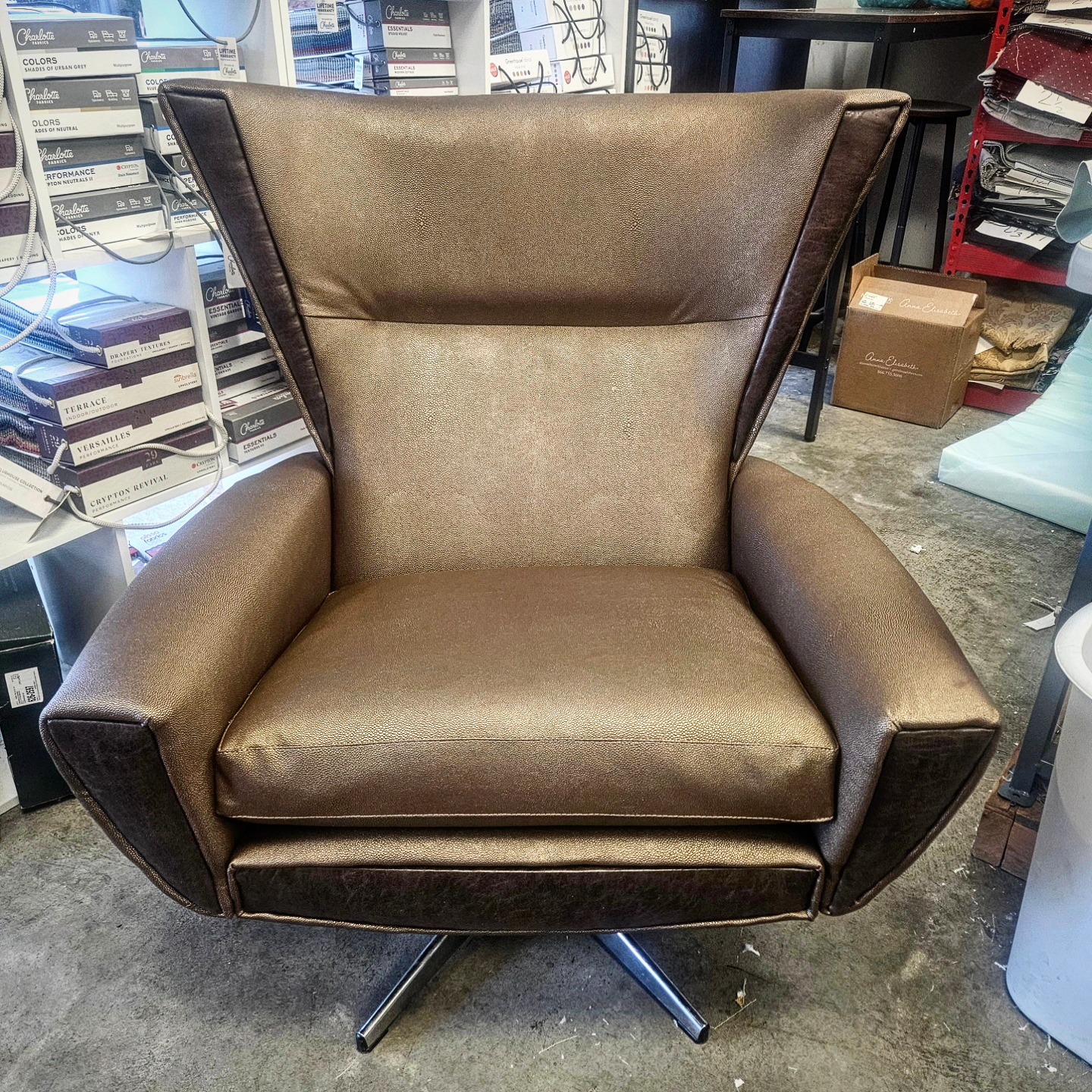 Bronze leather wing chair on a swivel base — custom upholstery work