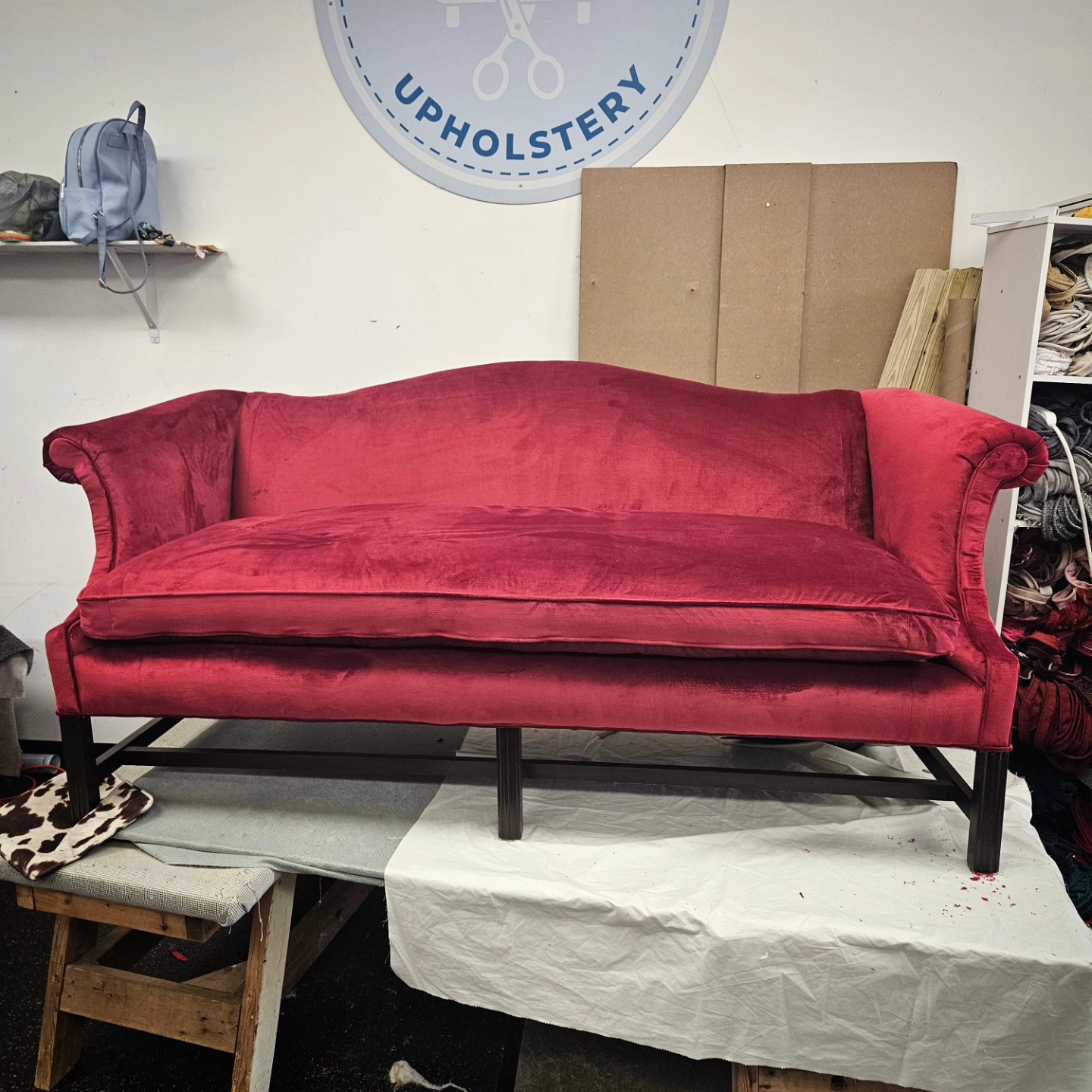 Camelback sofa in deep red velvet, finished in our Clemmons workshop