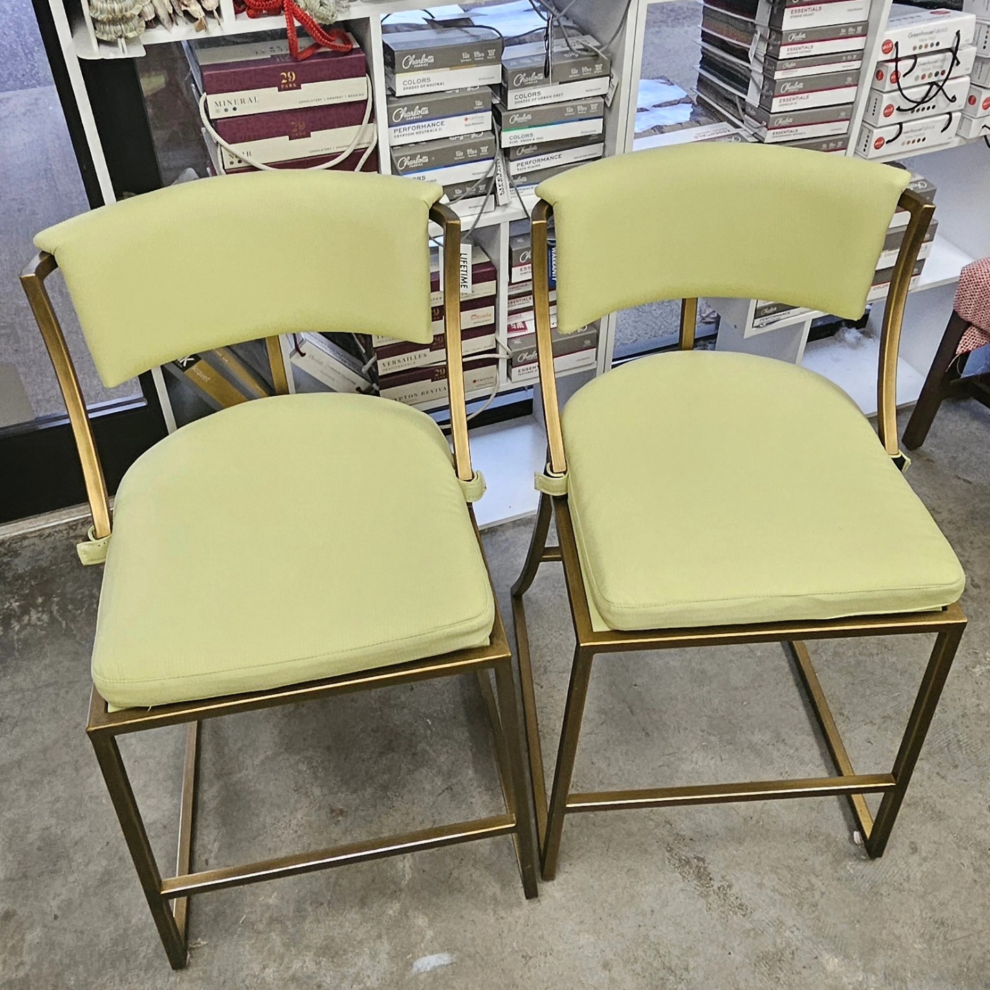 Custom counter stools in chartreuse with brass frames